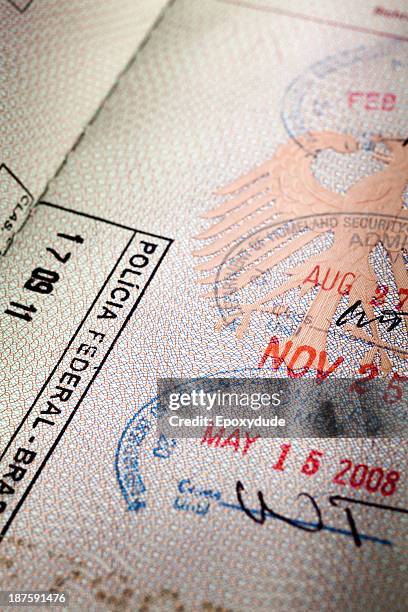 an open passport with several entrance stamps on the pages - passport page stock pictures, royalty-free photos & images