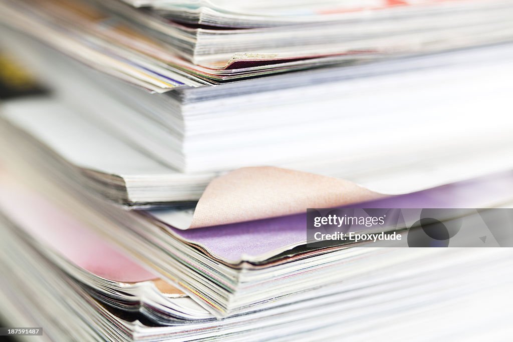 A messy stack of well thumbed through magazines