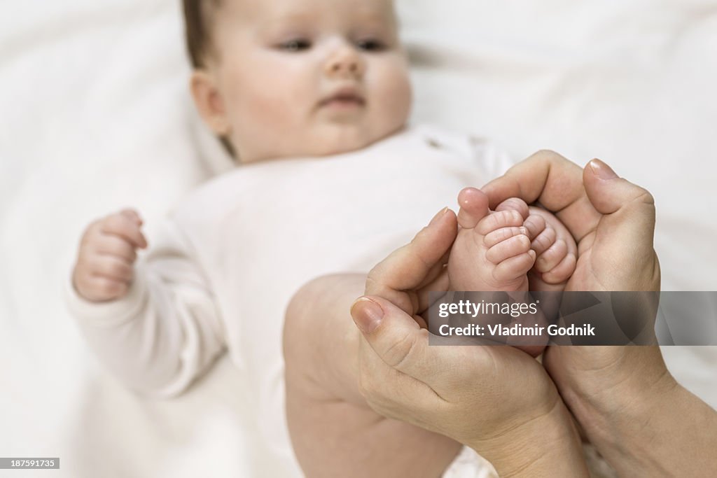 Mother holding child's feet