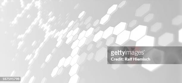 hexagons connected into molecular like structures on a gray background - chemistry stock illustrations