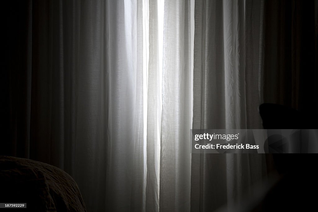 Sunlight coming in through slightly parted curtains in a bedroom