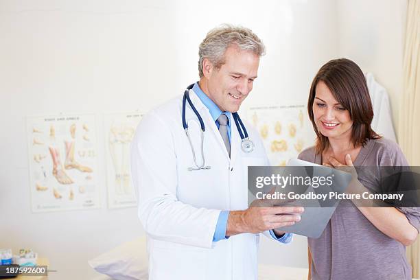 giving his expert medical opinion - doctor giving good news stock pictures, royalty-free photos & images