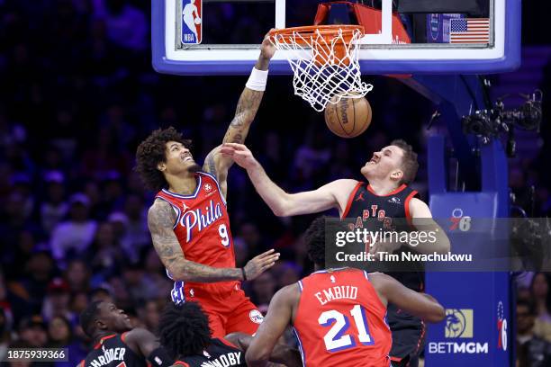 Kelly Oubre Jr. #9 of the Philadelphia 76ers dunks past Jakob Poeltl of the Toronto Raptors during the second quarter at the Wells Fargo Center on...