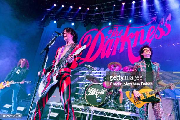 Dan Hawkins, Justin Hawkins and Frankie Poullain of The Darkness perform at The Roundhouse on December 22, 2023 in London, England.