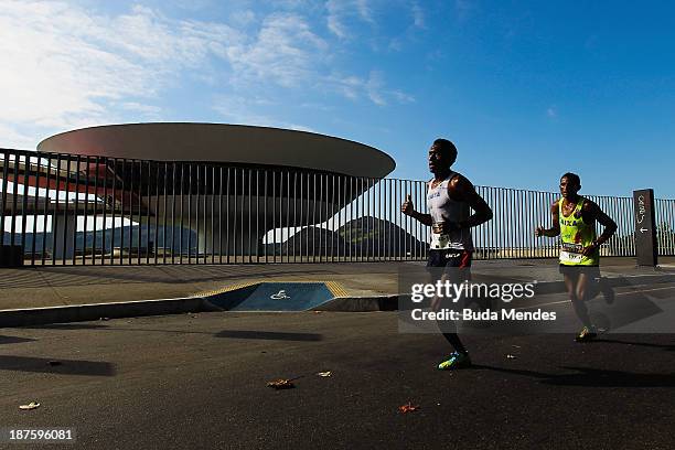 Athletes run in front of the Museum of Contemporary Art during the Half Marathon Faz um 21 Embratel at Orla de Niteroi on November 10, 2013 in Rio de...