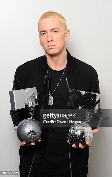 Eminem poses in his dressing room with the 'Best Hip Hop' and 'Global Icon' awards during the MTV EMA's 2013 at the Ziggo Dome on November 10, 2013...