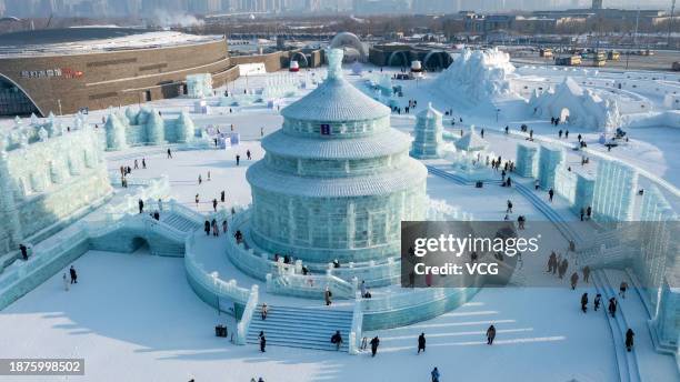 Tourists visit the 25th Harbin Ice and Snow World, one of the world's leading theme parks featuring large-scale ice and snow sculptures, on December...
