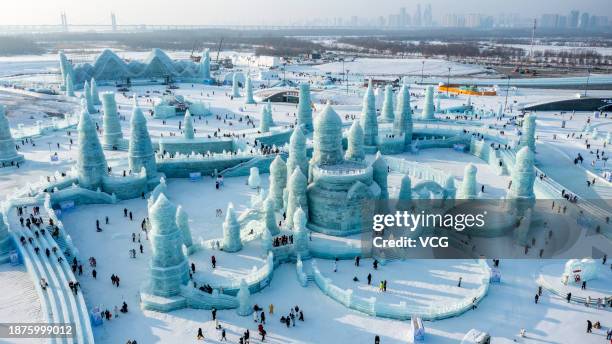 Tourists visit the 25th Harbin Ice and Snow World, one of the world's leading theme parks featuring large-scale ice and snow sculptures, on December...