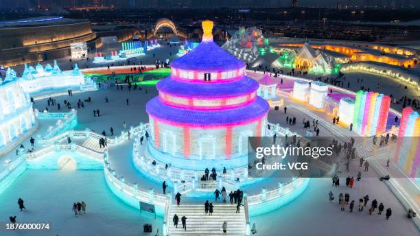 Tourists visit the 25th Harbin Ice and Snow World, one of the world's leading theme parks featuring large-scale ice and snow sculptures, on December...