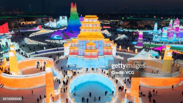 Tourists visit the 25th Harbin Ice and Snow World, one of the world's leading theme parks featuring large-scale ice and snow sculptures, on December...