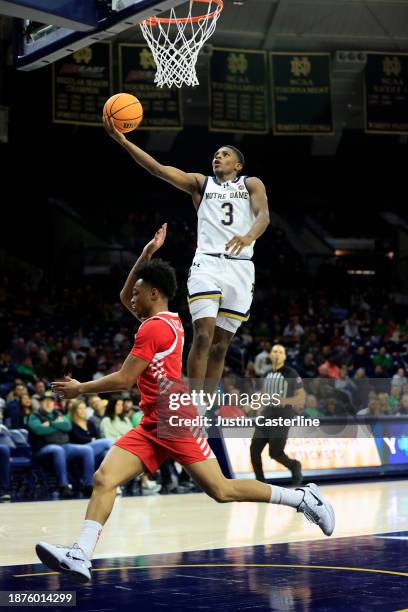 Markus Burton of the Notre Dame Fighting Irish takes a shot while defended by Jadin Collins of the Marist Red Foxes during the first half at Joyce...