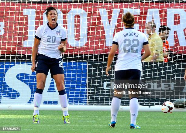 Forward Abby Wambach of the U.S. Women's National Team celebrates with midfielder Amber Brooks after scoring on a penalty kick against Brazil on...