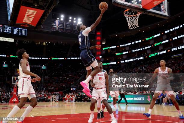 Olivier-Maxence Prosper of the Dallas Mavericks goes up for a lay up in front of Jae'Sean Tate of the Houston Rockets in the first half at Toyota...
