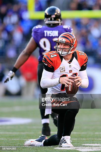 Quarterback Andy Dalton of the Cincinnati Bengals gets up after being sacked by defensive end DeAngelo Tyson of the Baltimore Ravens during the...