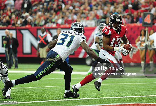 Darius Johnson of the Atlanta Falcons makes a catch for a touchdown against Kam Chancellor of the Seattle Seahawks at the Georgia Dome on November...