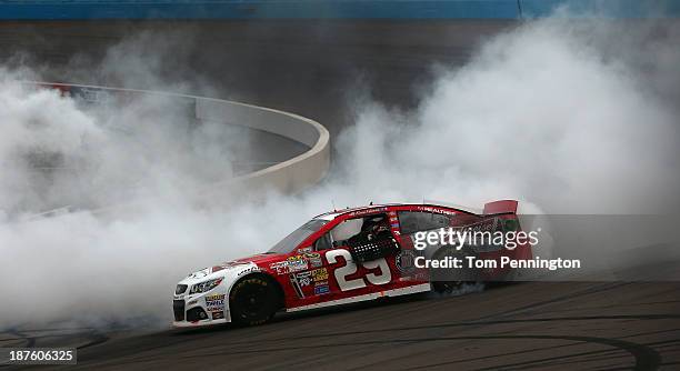 Kevin Harvick, driver of the Budweiser Chevrolet, celebrates with a burnout after winning the NASCAR Sprint Cup Series AdvoCare 500 at Phoenix...