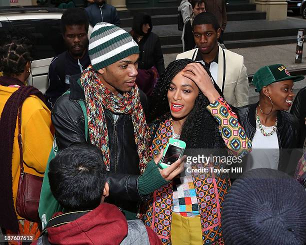 Singer Solange Knowles poses with fans to celebrate the release of her "Saint Heron" compilation album outside Opening Ceremony in Soho on November...