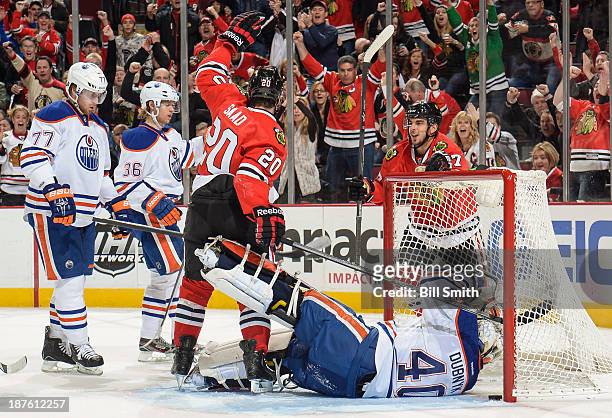 Brandon Saad and Brandon Pirri of the Chicago Blackhawks react after Saad scored on goalie Devan Dubnyk of the Edmonton Oilers in the first period,...