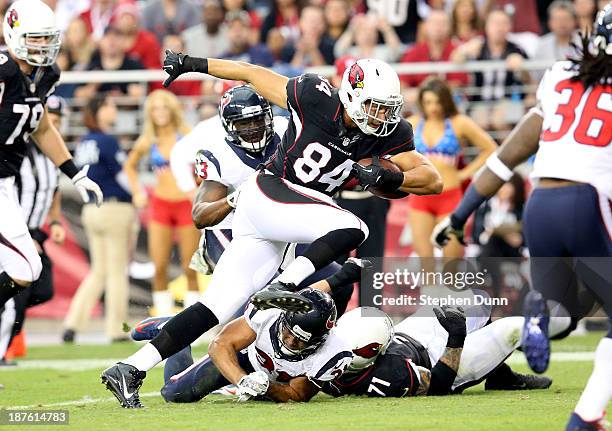 Tight end Rob Housler of the Arizona Cardinals carries the ball on a 12 yard touchdown pass play against the Houston Texans at University of Phoenix...