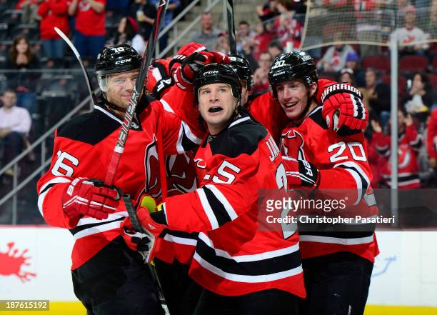 Cam Janssen of the New Jersey Devils is congratulated after scoring a second period goal against the Nashville Predators on November 10, 2013 at the...