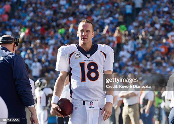 Peyton Manning of the Denver Broncos walks with the football on the sideline during the football game against the San Diego Chargers at Qualcomm...