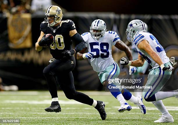 Tight end Jimmy Graham of the New Orleans Saints runs with the ball against the Dallas Cowboys during a game at the Mercedes-Benz Superdome on...