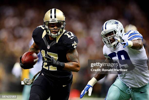 Wide receiver Robert Meachem of the New Orleans Saints runs with the ball as inside linebacker Ernie Sims of the Dallas Cowboys defends during a game...