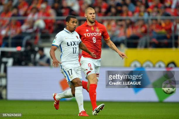 Wellington Daniel Bueno of Kashima Antlers and Robin Simovic of Nagoya Grampus compete for the ball during the J.League J1 first stage match between...