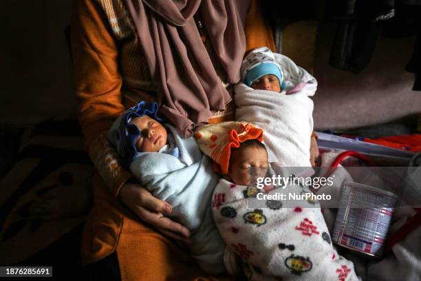 Iman Al-Masri, a displaced Palestinian, is giving birth to quadruplets in the shelter center at the Rufaydah School in Deir Balah in the central Gaza...