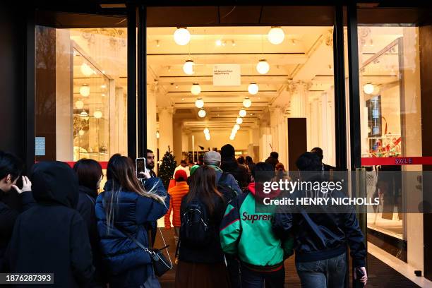 Shoppers queue to enter Selfridges department store ahead of their Boxing Day sale, in central London, on December 26, 2023.