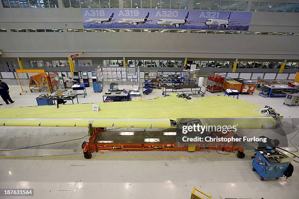 Technicians work on the wing of an Airbus A320 during construction at the Airbus SAS factory on November 7, 2013 in Broughton, United Kingdom. The...