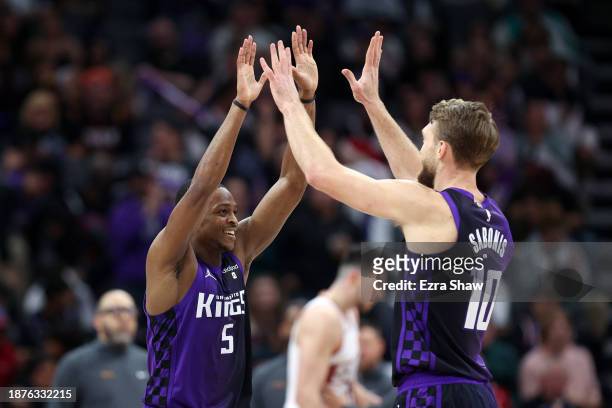 De'Aaron Fox and Domantas Sabonis of the Sacramento Kings celebrate during the second half of their win over the Phoenix Suns at Golden 1 Center on...