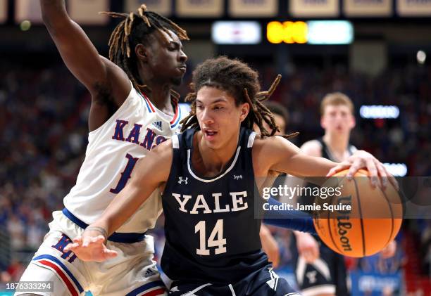 Casey Simmons of the Yale Bulldogs controls the ball as Jamari McDowell of the Kansas Jayhawks defends during the game at Allen Fieldhouse on...