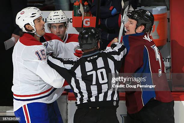 Linesman Derek Nansen seperates George Parros of the Montreal Canadiens and Cody McLeod of the Colorado Avalanche at Pepsi Center on November 2, 2013...