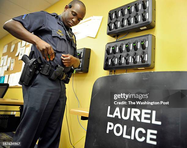 Laurel Police Department Officer Marcus Currie picked up his body camera gear checked before the start of his shift on Tuesday, October 15, 2013 in...