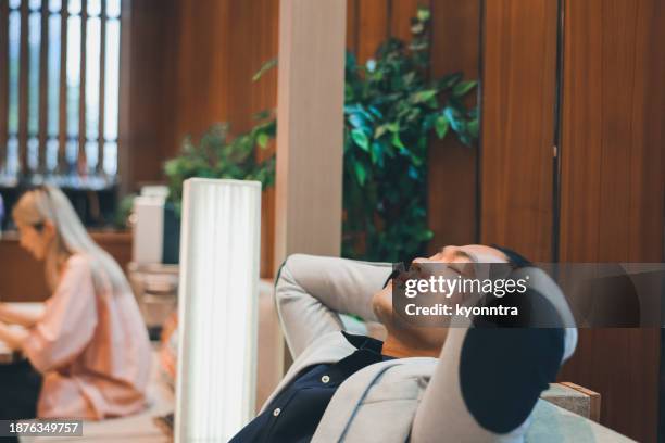 asian businessman relaxing at cafe - vip lounge stock pictures, royalty-free photos & images