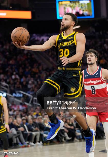 Stephen Curry of the Golden State Warriors shoots a layup against the Washington Wizards during the first half at Chase Center on December 22, 2023...