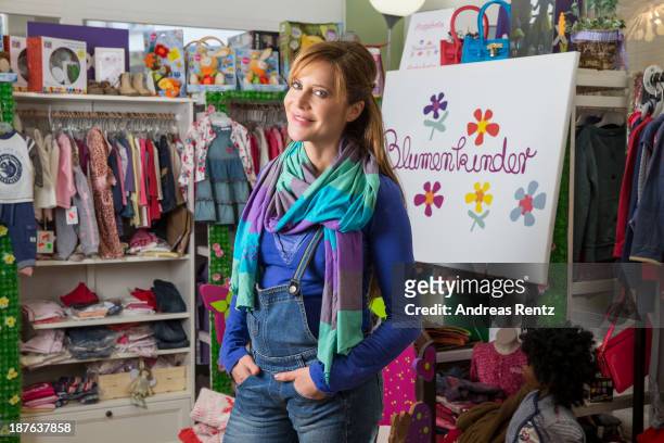 Doreen Dietel poses during a portrait session announcing her pregnancy at the baby clothing store 'Blumenkinder' on November 9, 2013 in Munich,...