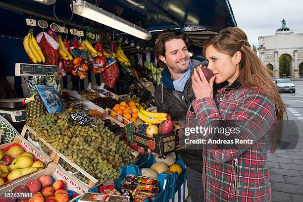 Doreen Dietel and her partner Tobias Guttenberg pose during a portrait session announcing her pregnancy at a fruit stand on November 9, 2013 in...