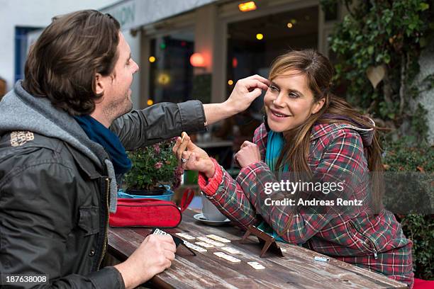 Doreen Dietel and her partner Tobias Guttenberg play the game Rummy during a portrait session announcing her pregnancy at cafe Gartensalon on...