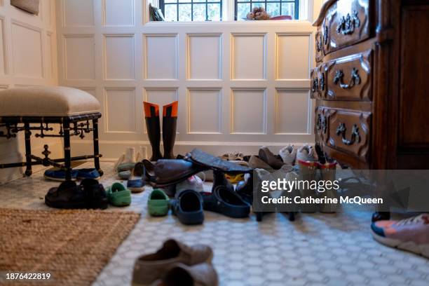shoes in family’s foyer - tidy room stock pictures, royalty-free photos & images