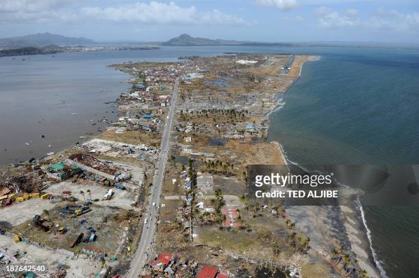 This aerial photo shows destroyed houses and the airport terminal in the city of Tacloban, Leyte province, in the central Philippines on November 11...