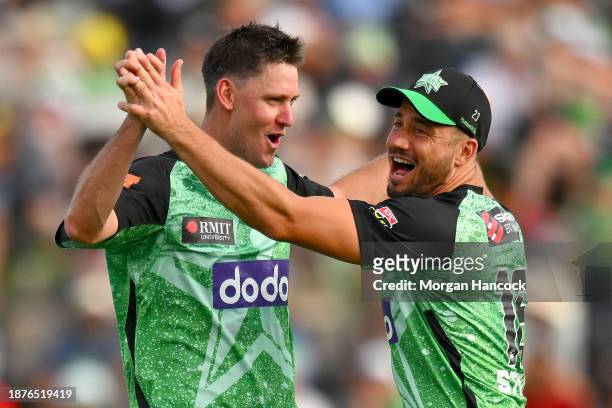 Beau Webster and Marcus Stoinis of the Melbourne Stars celebrate the wicket of Jason Sangha of Sydney Thunder during the BBL match between Melbourne...