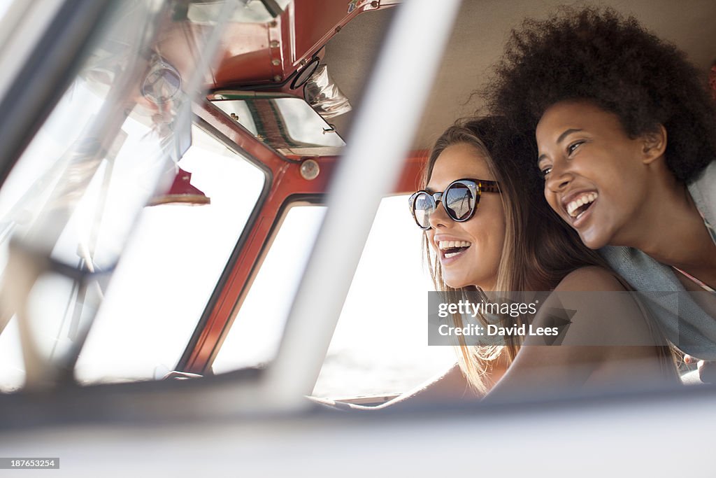 Smiling friends in camper van