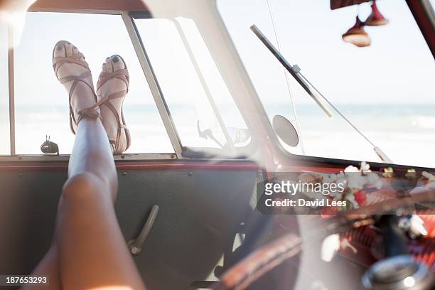woman relaxing in camper van, legs only - sandales photos et images de collection