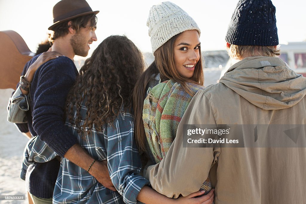 Friends walking together on beach