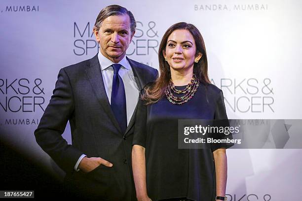 Marc Bolland, chief executive officer of Marks & Spencer Group Plc, left, stands with Nita Ambani, the wife of Mukesh Ambani, the Indian billionaire...