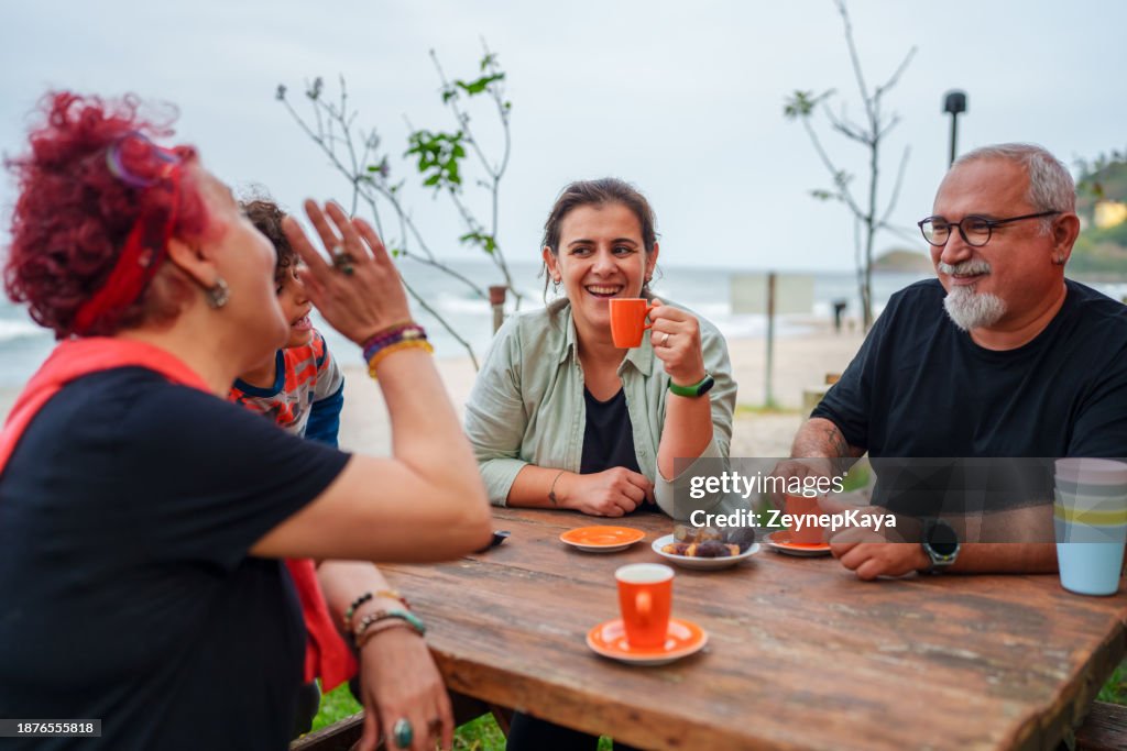 Family is at the picnic next to sea