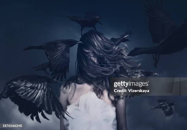 young woman in motion with flying ravens - crow bird stock pictures, royalty-free photos & images