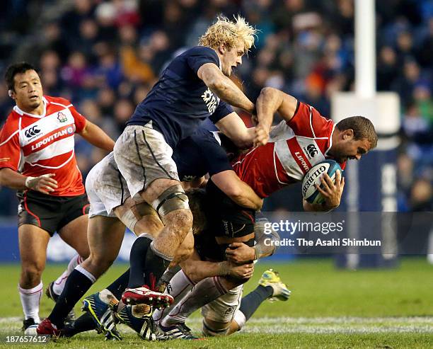 Michael Broadhurst of Japan is tackled by Gary Richie and David Denton of Scotland during the Scotland v Japan Autumn International Series Match at...